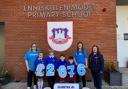Miss Amber Elliott and parent Mrs. Claire Elliott, accompanied by pupils Carly, Henry, Bobby and Jackson, presenting a cheque for £2,676 to Naomi (far right) representing Diabetes UK.