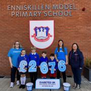 Miss Amber Elliott and parent Mrs. Claire Elliott, accompanied by pupils Carly, Henry, Bobby and Jackson, presenting a cheque for £2,676 to Naomi (far right) representing Diabetes UK.