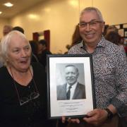 The late Lt. Col. George Saunderson's children, Irene and Jim, holding a picture of their father at the night in Teemore.