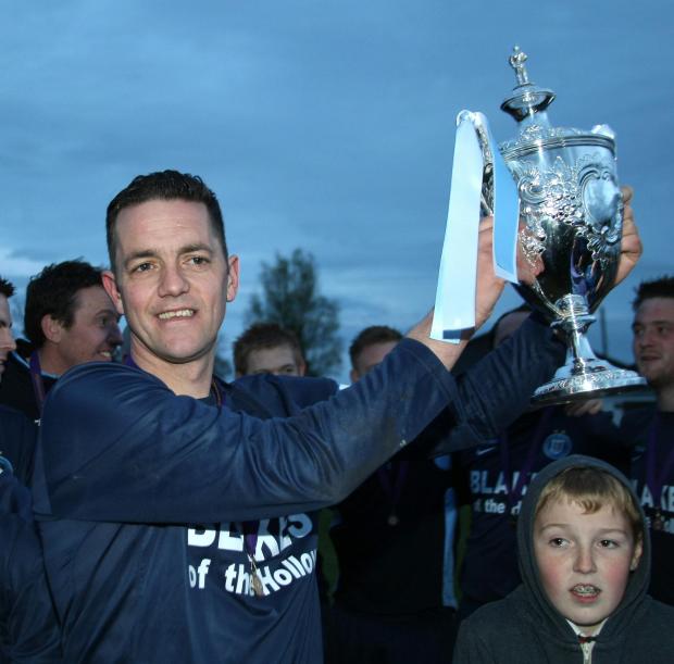 Impartial Reporter: Gary Beckett lifts the Mulhern Cup.