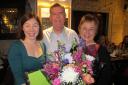 Sarah Saunderson (left) presenting Brian Donaldson and his wife Diane with gifts.
