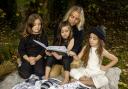 'Wildkind' creator Ciara Tinney reading to her children, Adabelle, Birdie Blue and Fiadh Rós, who are wearing her Wildkind Irish linen collection. Photo: Liam McBurney/PA Wire.
