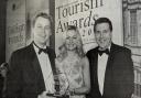 Pictured are Terry and Mary McCartney, Belmore Court Motel, Enniskillen who won the Information and Technology Initiative of the Year Award at the NI Tourism Awards being congratulated by NITB Chief Executive, Alan Clarke. 2003.