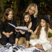 'Wildkind' creator Ciara Tinney reading to her children, Adabelle, Birdie Blue and Fiadh Rós, who are wearing her Wildkind Irish linen collection. Photo: Liam McBurney/PA Wire.