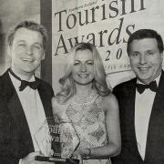 Pictured are Terry and Mary McCartney, Belmore Court Motel, Enniskillen who won the Information and Technology Initiative of the Year Award at the NI Tourism Awards being congratulated by NITB Chief Executive, Alan Clarke. 2003.