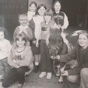 Diane Sheridan, Enniskillen Campus, shows a miniature pony to local children.