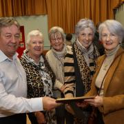 Tony and Collette Hart with Carmel Farry, Angela Cochrane and Paula Cassidy with one of the old school roll books.