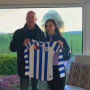 Darren Crocker, North Melbourne AFLW coach presented Bláithín with a jersey when he visited her last weekend.