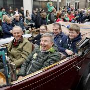 Lord Brookeborough and Fr. Brian D'Arcy taking part in the parade in a vintage car.
