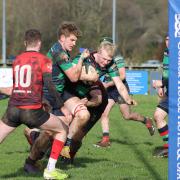 David Stinson gives Joel Busby a helping hand towards the Midleton try line.