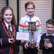 Uma De Naipir, ERGS, winner of the Verse Speaking Bursary, Year 10; Eve McManus, Tattygar PS; winner of the Own Poetry section; and Grace Cureton, St. Mary's NTB, first place, Own Poetry, P4.