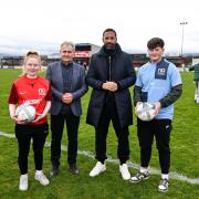 Rio Ferdinand and Paddy Harte, Chair of the IFI, with Phoebe Wallace from Enniskillen, and Torry Sloan from Omagh.