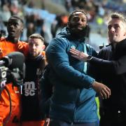 Ipswich Town manager Kieran McKenna (right) and player Janoi Donacien celebrate in front of the fans after the final whistle in the Sky Bet Championship.