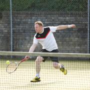 Clive Funston stretches to make a forehand.