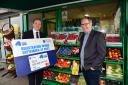 Announcing the next phase of the High Street Scheme, Economy Minister Gordon Lyons joins Michael Goggin of Michel’s Fresh Fruit and Vegetables on the Ormeau Road, Belfast.
