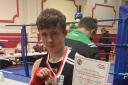 Erne Boxing Club's Oisin Gilheaney with his medal and certificate after taking gold at the Tyrone and Fermanagh Championships.