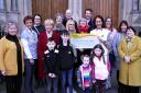 Members of St.Michaels Vigil Choir handing over a cheque to Friens of The Cancer Centre are front from left, Liam Kelly, Joe Kelly, Saoirse Howard and Lucy Kelly. Centre row from left, Lenni Browne-Reid, FOCC; Breda McKervey, FOCC; Freda Hutson, Sharon