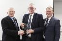 John Martin, Kesh, receives his Long Service Award from Michael Smale, left, chairman, Holstein UK; and vice-chairman Wallace Gregg.