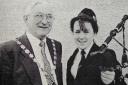 Pictured are Mr. Caldwell McClaughry, Chairman of Fermanagh District Council, chatting with young piper, Theresa McGirr, from Breagho, Enniskillen at the opening of the new community hall.