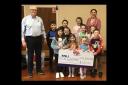 Ballinamallard PS pupils and principal Christina McEldowney pictured presenting a cheque to Peter Scott, RNLI.