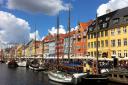 The iconic Nyhaven area in Copenhagen - a city famous for making travel by bicycle a fundamental part of day to day living in the bustling city, helping citizens' health and supporting the environment. Stock image.