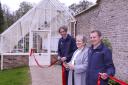 Barbara Corscadden, wife of the late David Corscadden, (Former Head Gardner), cutting the tape to offically open the new Glass Houses at Florence Walled Garden. Also included are from left, Mark Donnelly, Assistant Gardner and Ian Marshall, Senior