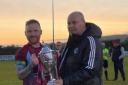 Fermanagh and Western League chairman, Neil Jardine, presents the Mercer Cup to Tummery Athletic captain, Aidy McCaffrey.
