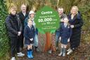 Centra Trory owner Stuart Roulston (second left) and son Alex, visit Enniskillen Integrated Primary School which received 50 trees for its eco school project. They met Year 7 pupils Imogen Heap and Lucy Gallagher, parents Leona Connolly (third left) and