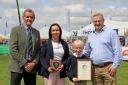 Holstein UK President, John Jamieson presenting the award to the Armstrong family; Sharon, Charles and Gareth from the Coolnagrane Herd.