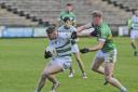 Ronan McCaffery fends of the challenge of Cormac McElroy