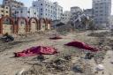 Bodies of Palestinians who were killed in the Israeli bombardment of the Gaza Strip are covered on the main road in Gaza City on Tuesday, January 2. Photo: AP.