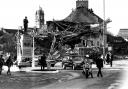 A funeral passes the rubble-filled site of the Enniskillen Remembrance Day Bombing that occured on November 8, 1987.