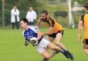 A Devenish player goes to ground under pressure from Erne Gaels Brian Mullin.