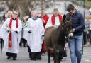 The Palm Sunday procession from the cathedral hall to St. Macartin's Cathedral, Enniskillen, led by Tom the donkey.
