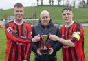 Niall Keenan and Jamie McCaffrey accept the winning tophy from Neil Jardine.