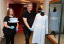 Claire Browne, Volunteer, Fermanagh County Museum and Colin Fawcett, Assistant Conservator, Fermanagh County Museum, installing the original garments worn By Her MaJesty Queen Elizabeth 11 on her latest visit to Enniskillen.