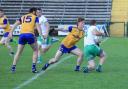 Martin McGrath shields the ball from Josh Horan as he tries to evade the tackle