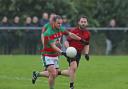 Stephen Phair steadys to drive the ball forward with Barry Flanagan keeping pace