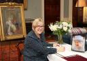 Marion Saunderson, signing the book of condolences in memory of Her Majesty Queen Elizabeth II in Castle Coole House.