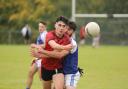 Luca McCusker gets the ball away as Conor McGowan attempted to close him down.