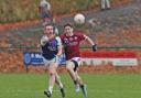 Barry Mulrone fists the ball clear as Enda O'Connell closes in