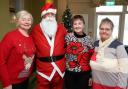 Attending the West End Tea Pots Christmas Coffee Morning are Margaret McGovern, Santa Claus, Rosie Crawford and June Livingstone.