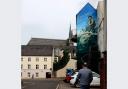 Enniskillen fisherman mural by Kevin McHugh, commissioned by Enniskillen BID.