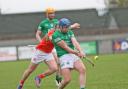 Ryan Bogue makes contact with the sliotar before Niall Lennon can get a hook in.