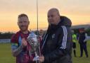 Fermanagh and Western League chairman, Neil Jardine, presents the Mercer Cup to Tummery Athletic captain, Aidy McCaffrey.
