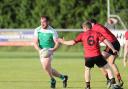 Sean Quigley turns back from the challenge of Mark Gavin