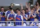 Martin Doherty lifts the trophy for Devenish.