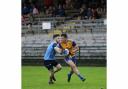 Ciaran Smith of Enniskillen is challenged by Belcoo's Dean McDermott during Tuesday night's encounter at Brewster Park.