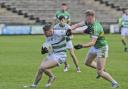 Ronan McCaffery fends of the challenge of Cormac McElroy