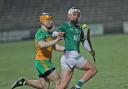 Luca McCusker keeps control of the sliotar with Oisin Kelly pressing.